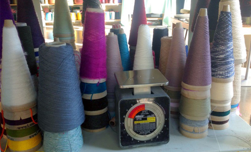 colorful cones of yarn waiting to be weighed